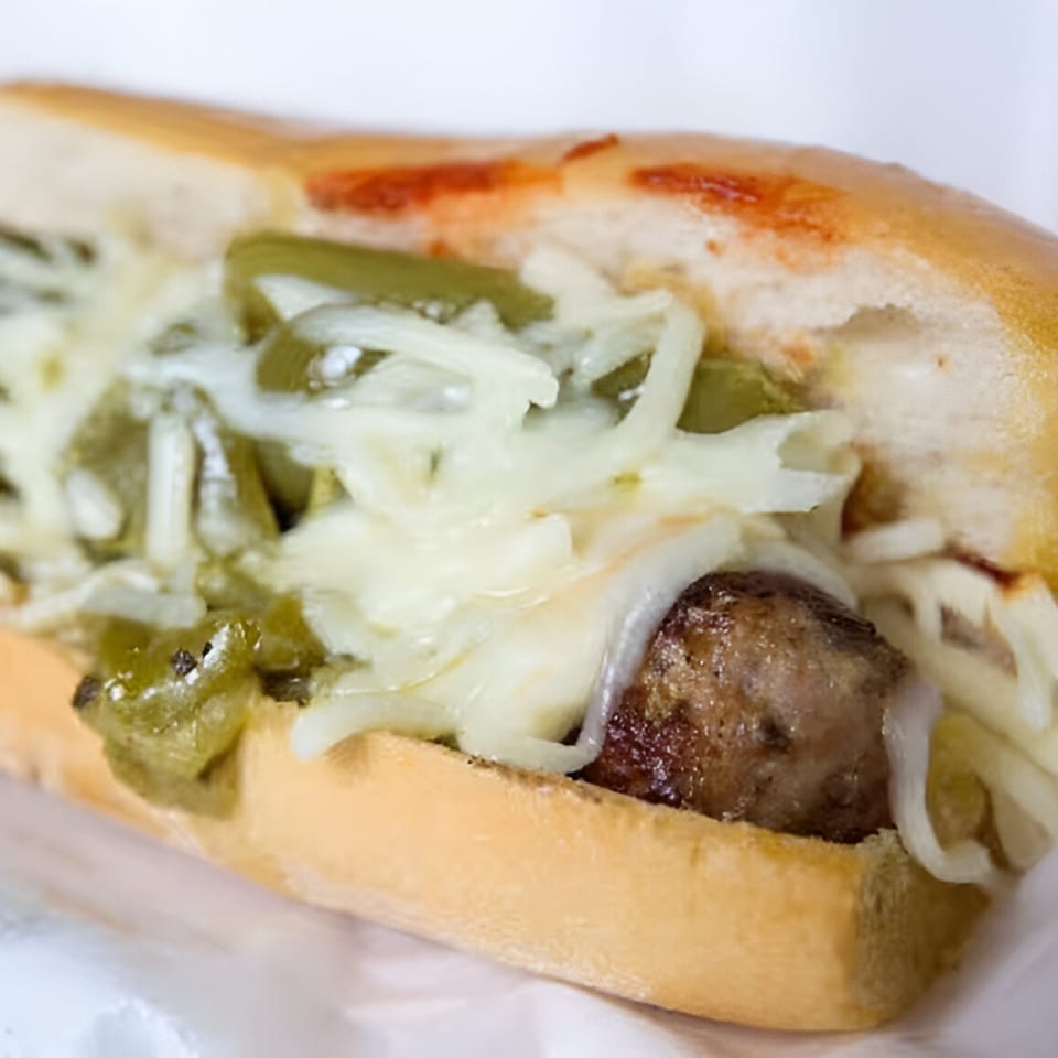 Badda Bing's Italian sausage sandwich with melted cheese and green peppers on a bun.